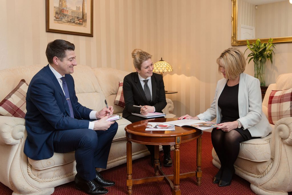 Funeral arranger discussing options with a family